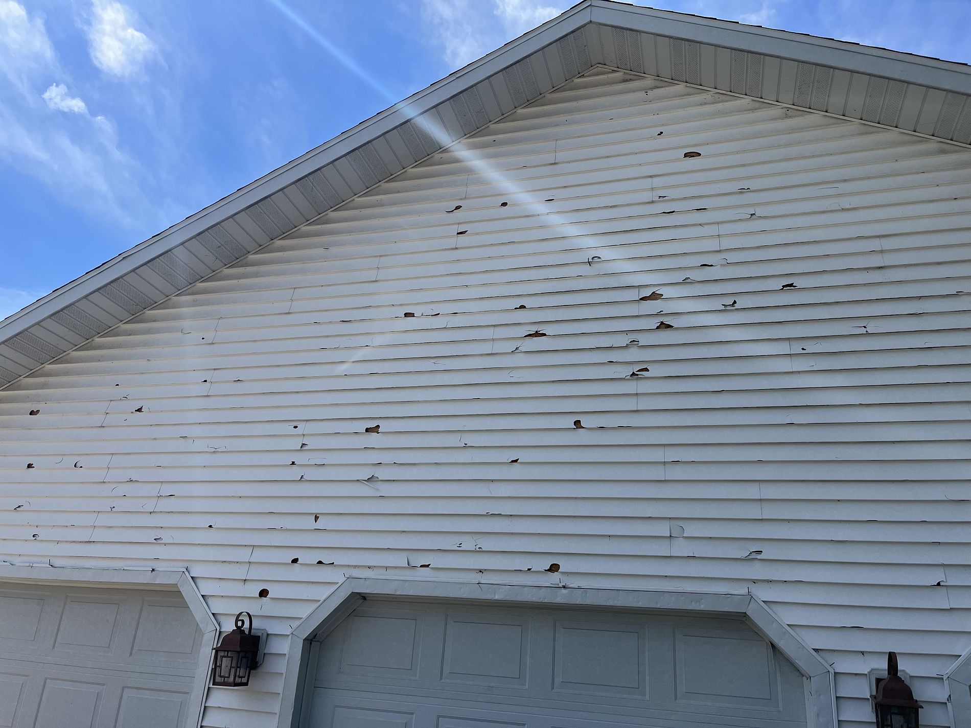 hail damage caused to vinyl siding This is what hail damage looks like on vinyl siding